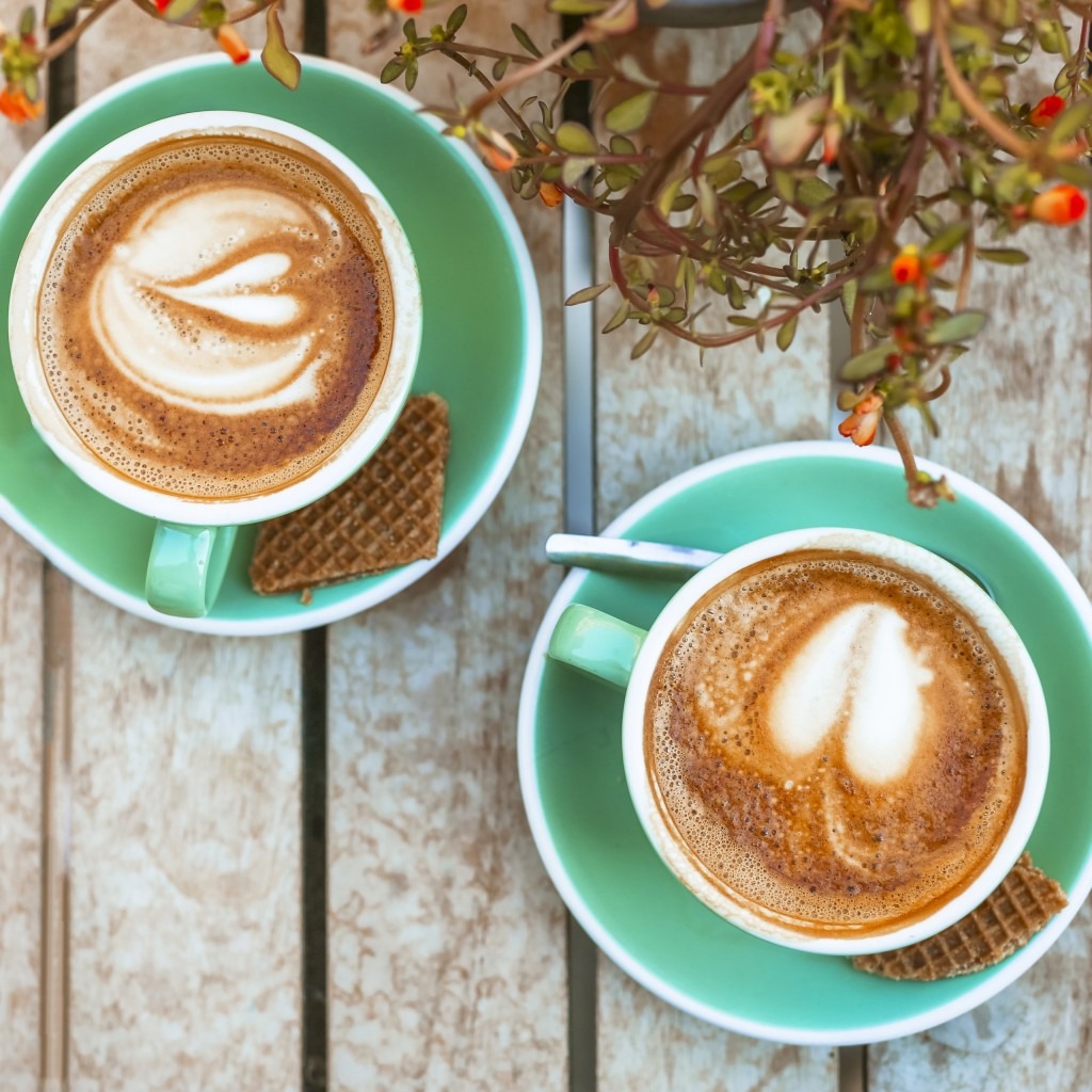 two coffee cups with heart latte art